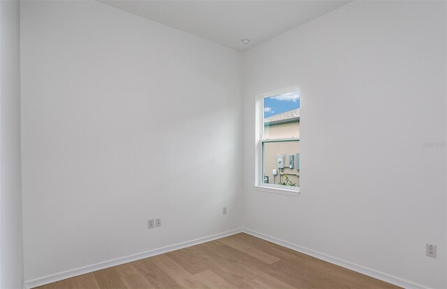 unfurnished room with light wood-style floors and baseboards