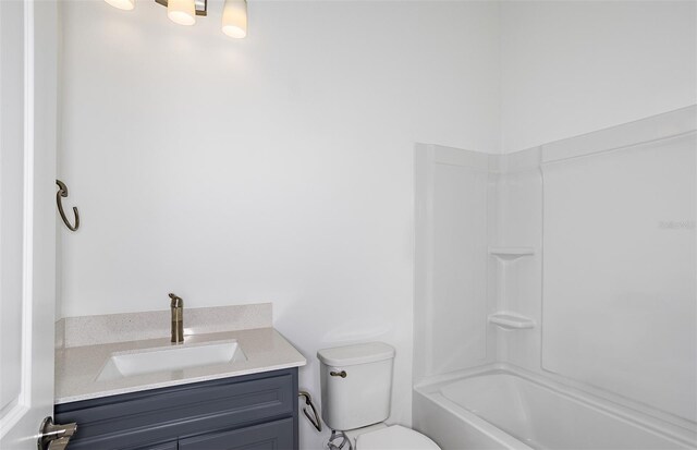 bathroom featuring vanity, toilet, and  shower combination