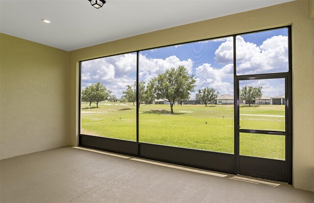 unfurnished sunroom with view of golf course
