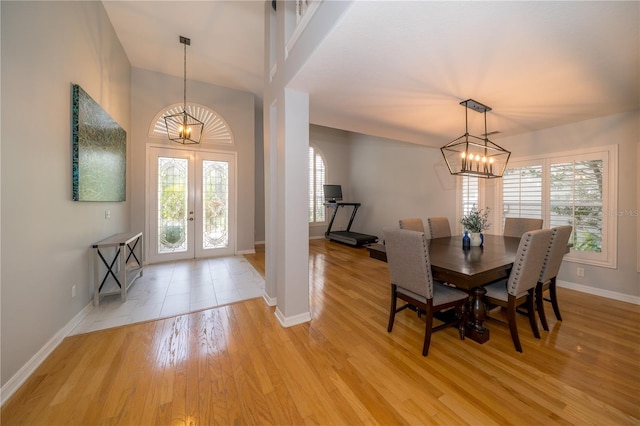 2206 Green Oaks Ln, Tampa, FL 33612 - entrance foyer featuring baseboards, french doors, an inviting chandelier, and light wood finished floors