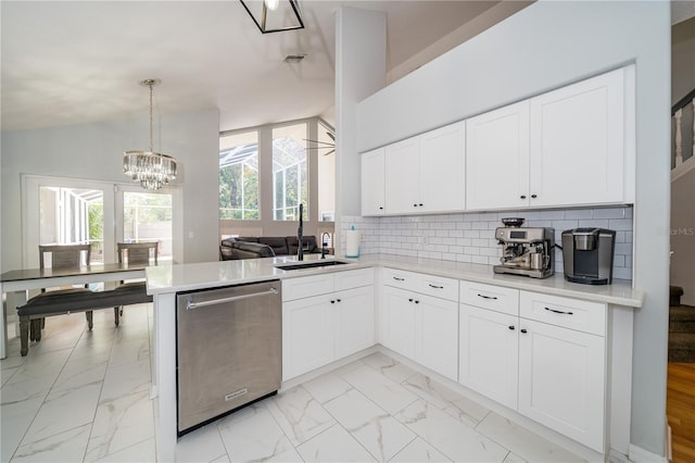 2206 Green Oaks Ln, Tampa, FL 33612 - kitchen featuring backsplash, a sink, stainless steel dishwasher, lofted ceiling, and marble finish floor