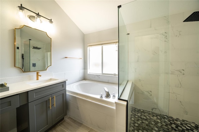 2206 Green Oaks Ln, Tampa, FL 33612 - bathroom featuring vanity, a bath, vaulted ceiling, and walk in shower