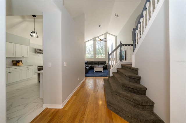 2206 Green Oaks Ln, Tampa, FL 33612 - interior space featuring high vaulted ceiling, stairway, ceiling fan, and visible vents