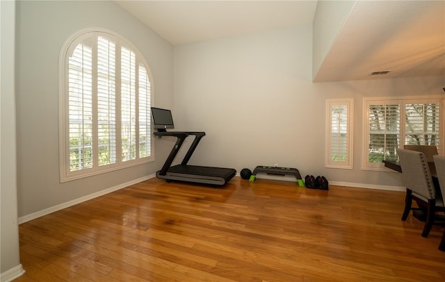 2206 Green Oaks Ln, Tampa, FL 33612 - workout room with baseboards, visible vents, and wood finished floors
