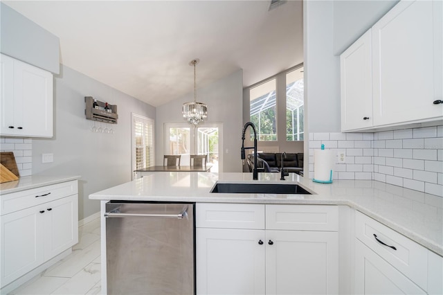 2206 Green Oaks Ln, Tampa, FL 33612 - kitchen featuring a sink, a chandelier, white cabinetry, dishwasher, and a peninsula