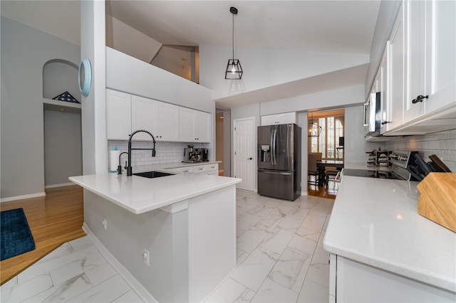 2206 Green Oaks Ln, Tampa, FL 33612 - kitchen with marble finish floor, a sink, stainless steel appliances, and a peninsula