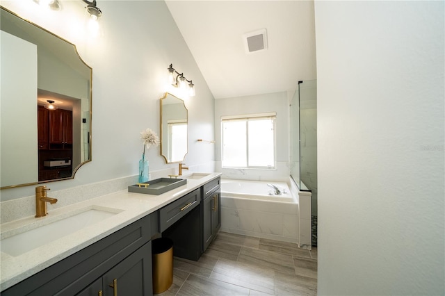 2206 Green Oaks Ln, Tampa, FL 33612 - bathroom featuring double vanity, visible vents, a sink, and a garden tub