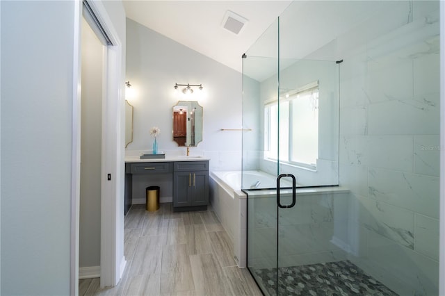 2206 Green Oaks Ln, Tampa, FL 33612 - bathroom featuring a shower stall, lofted ceiling, vanity, and a bath