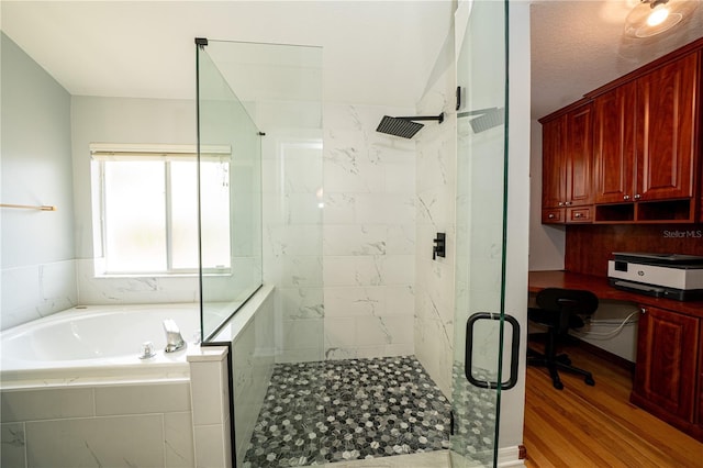 2206 Green Oaks Ln, Tampa, FL 33612 - bathroom featuring wood finished floors, a garden tub, and a shower stall