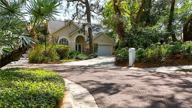 2206 Green Oaks Ln, Tampa, FL 33612 - view of front of house featuring stucco siding, an attached garage, and concrete driveway