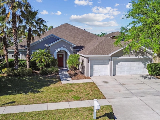 12304 Silton Peace Dr, Riverview, FL 33579 - view of front of house featuring an attached garage, roof with shingles, concrete driveway, and a front lawn