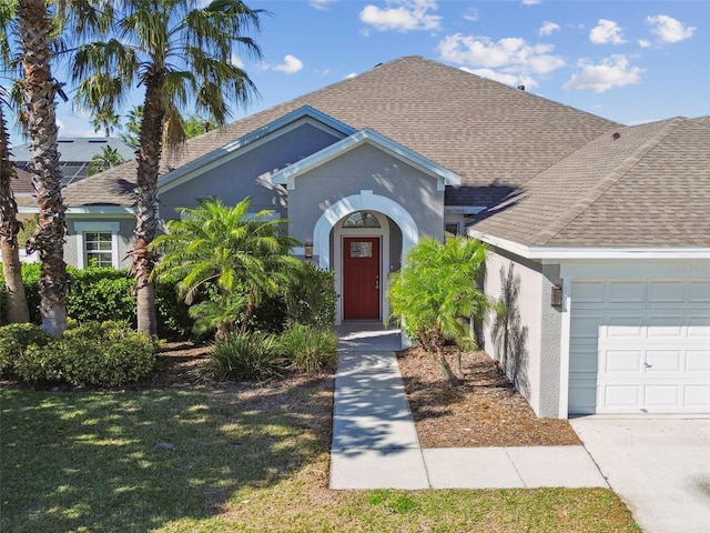 12304 Silton Peace Dr, Riverview, FL 33579 - view of front of home with stucco siding, an attached garage, a shingled roof, and a front yard