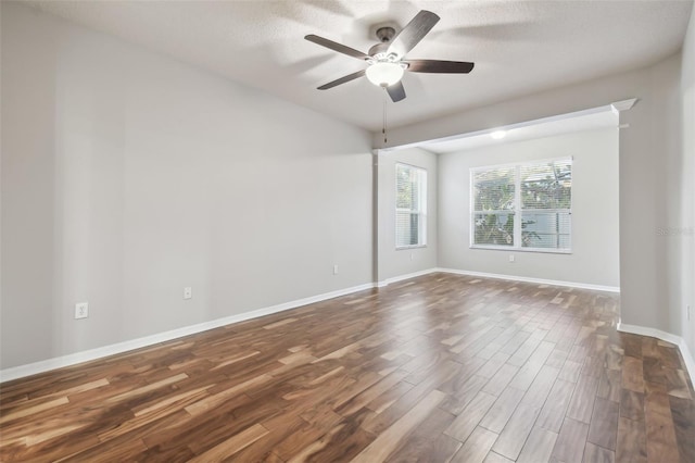 12304 Silton Peace Dr, Riverview, FL 33579 - empty room with baseboards, dark wood-style floors, and a ceiling fan