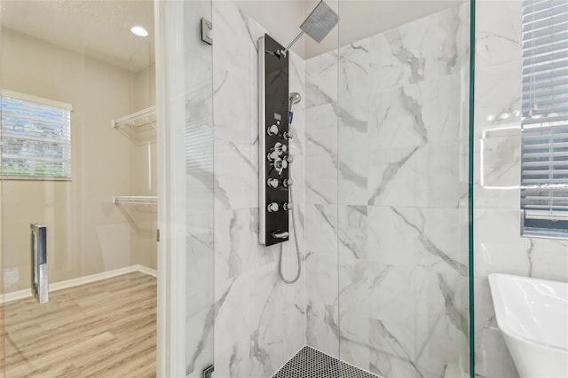 12304 Silton Peace Dr, Riverview, FL 33579 - bathroom with a marble finish shower, a walk in closet, baseboards, and wood finished floors