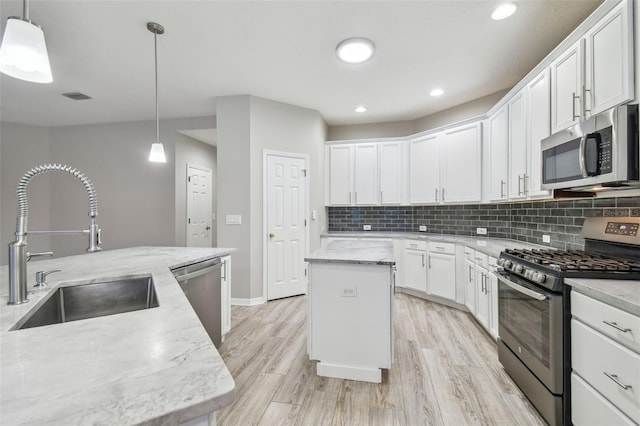 12304 Silton Peace Dr, Riverview, FL 33579 - kitchen with tasteful backsplash, visible vents, appliances with stainless steel finishes, and a sink