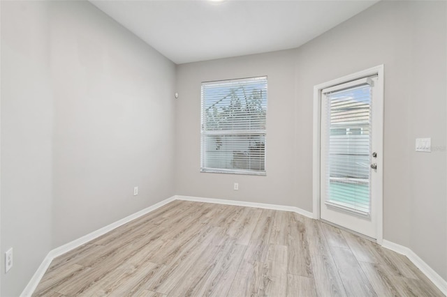 12304 Silton Peace Dr, Riverview, FL 33579 - unfurnished room with baseboards, a healthy amount of sunlight, and light wood-style flooring