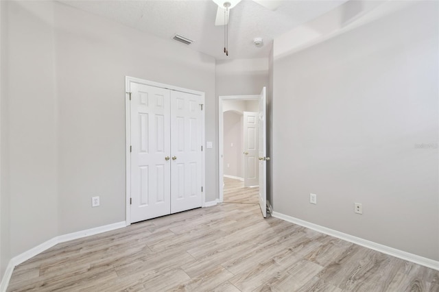 12304 Silton Peace Dr, Riverview, FL 33579 - unfurnished bedroom with baseboards, visible vents, light wood finished floors, ceiling fan, and a closet