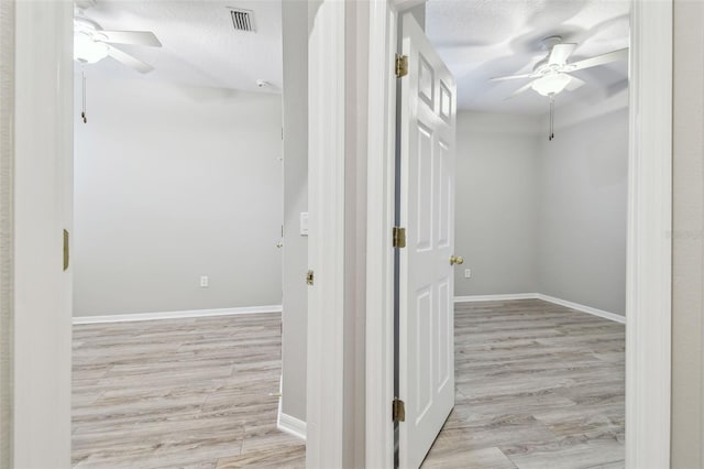 12304 Silton Peace Dr, Riverview, FL 33579 - hall featuring baseboards, a textured ceiling, and light wood-style flooring