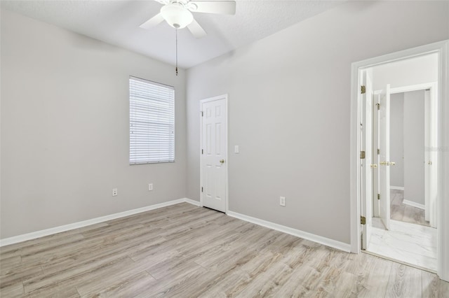 12304 Silton Peace Dr, Riverview, FL 33579 - unfurnished room featuring baseboards, a ceiling fan, and light wood finished floors