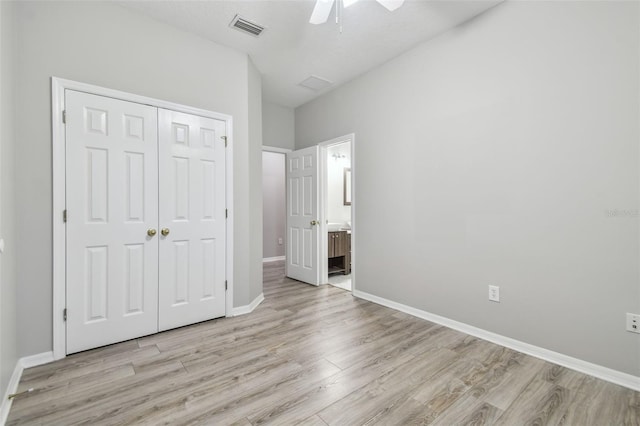 12304 Silton Peace Dr, Riverview, FL 33579 - unfurnished bedroom with baseboards, visible vents, light wood finished floors, a closet, and connected bathroom