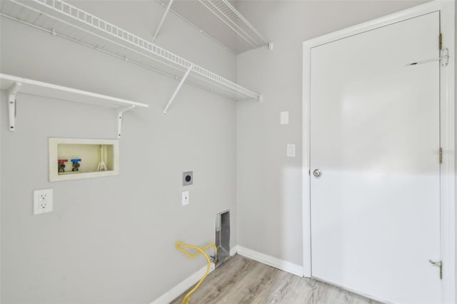 12304 Silton Peace Dr, Riverview, FL 33579 - clothes washing area with electric dryer hookup, light wood finished floors, baseboards, hookup for a washing machine, and laundry area