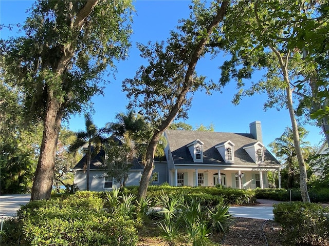 8910 Eagle Watch Dr, Riverview, FL 33578 - new england style home featuring a chimney