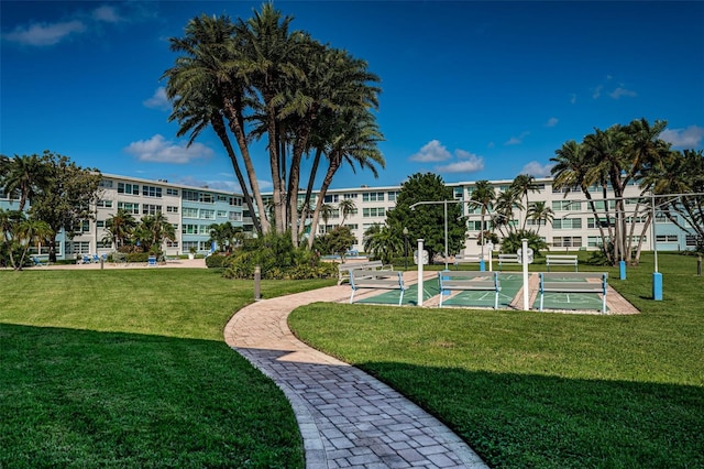 6201 2nd St E Unit 89, St Pete Beach, FL 33706 - view of community featuring a lawn and shuffleboard