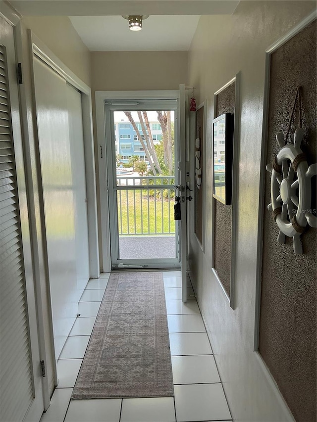 6201 2nd St E Unit 89, St Pete Beach, FL 33706 - doorway to outside with light tile patterned flooring