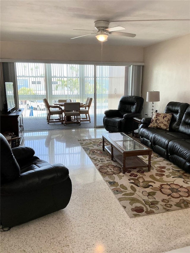 6201 2nd St E Unit 89, St Pete Beach, FL 33706 - living room featuring plenty of natural light, speckled floor, and ceiling fan