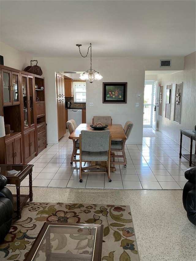 6201 2nd St E Unit 89, St Pete Beach, FL 33706 - dining space featuring visible vents, light speckled floor, a notable chandelier, and a healthy amount of sunlight