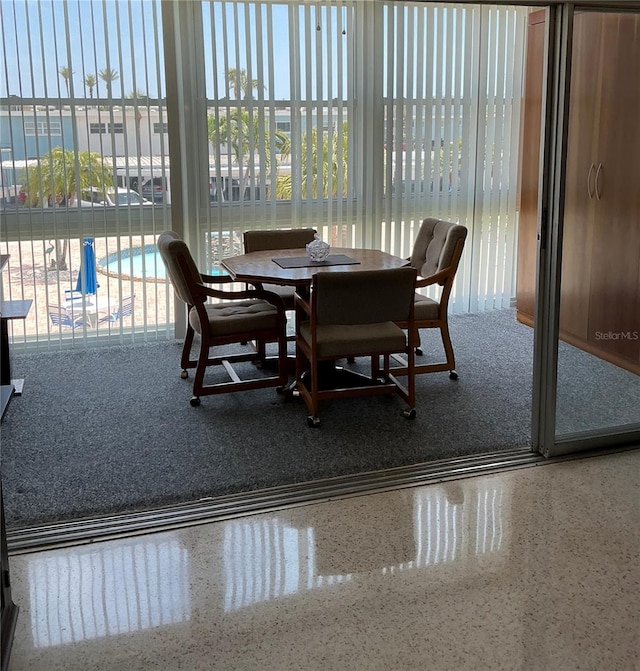 6201 2nd St E Unit 89, St Pete Beach, FL 33706 - dining room with speckled floor and a healthy amount of sunlight