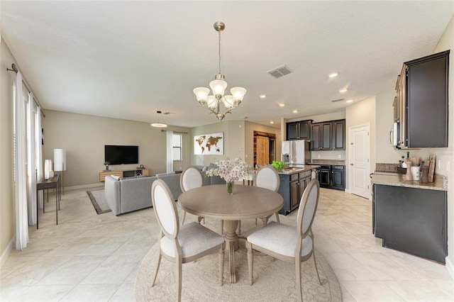 9917 Ivory Dr, Ruskin, FL 33573 - dining area with a chandelier, light tile patterned floors, and recessed lighting