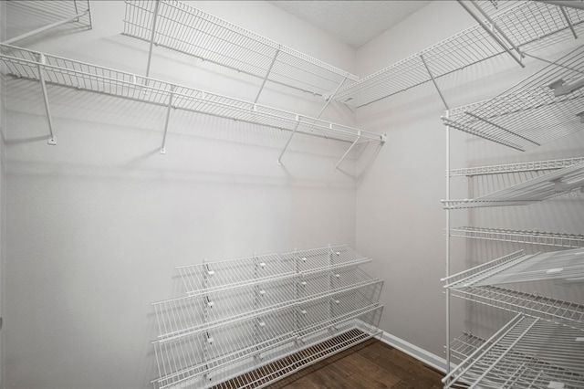 spacious closet with wood finished floors
