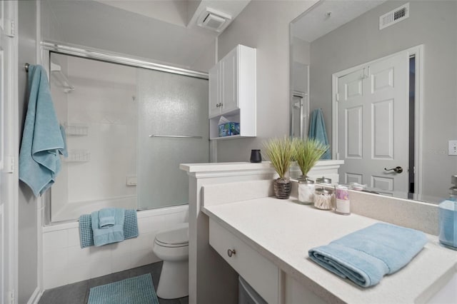 full bathroom featuring vanity, toilet, visible vents, and shower / bath combination with glass door