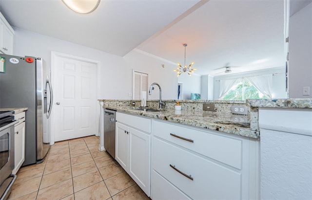 700 S Harbour Island Blvd Unit 404, Tampa, FL 33602 - kitchen with light tile patterned floors, white cabinetry, stainless steel appliances, and a sink