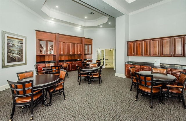 700 S Harbour Island Blvd Unit 404, Tampa, FL 33602 - dining area featuring baseboards, dark colored carpet, a towering ceiling, and ornamental molding