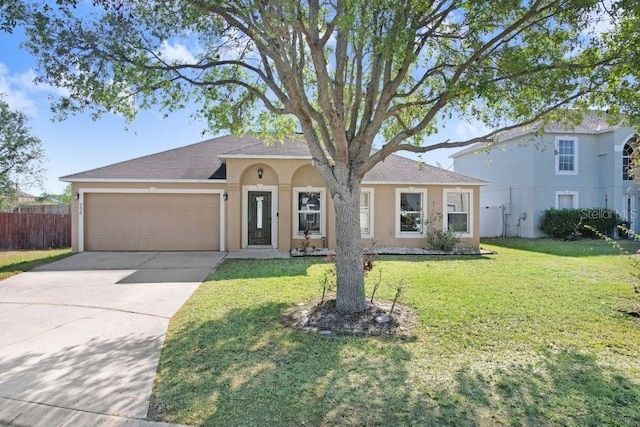 ranch-style house featuring concrete driveway, stucco siding, fence, an attached garage, and a front lawn