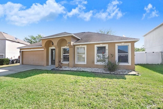 view of front of house featuring a front yard, concrete driveway, stucco siding, and an attached garage