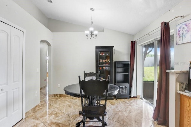 dining room featuring arched walkways, marble finish floor, vaulted ceiling, and a notable chandelier
