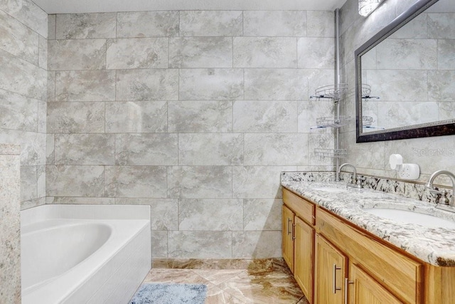 bathroom featuring tile walls, double vanity, a sink, and a bath