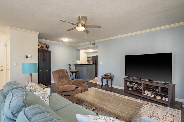 720 Lyndhurst St Unit 1121, Dunedin, FL 34698 - living area with ceiling fan, wood finished floors, baseboards, crown molding, and a textured ceiling