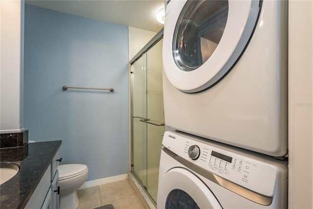 720 Lyndhurst St Unit 1121, Dunedin, FL 34698 - laundry area featuring estacked washer and dryer and light tile patterned floors