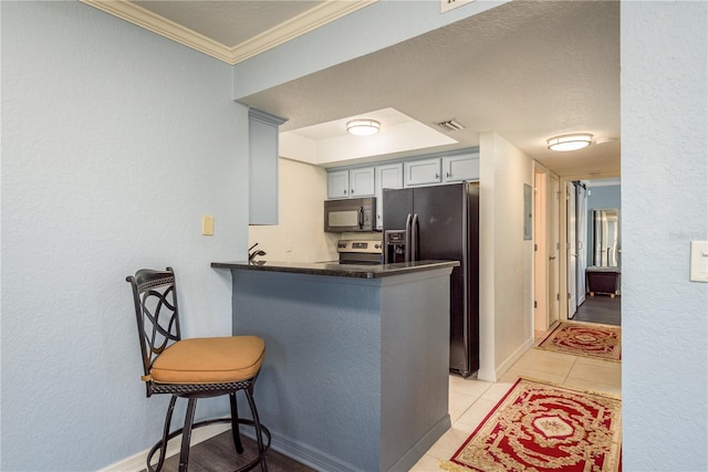 720 Lyndhurst St Unit 1121, Dunedin, FL 34698 - kitchen featuring black microwave, fridge with ice dispenser, stainless steel electric range oven, ornamental molding, and dark countertops
