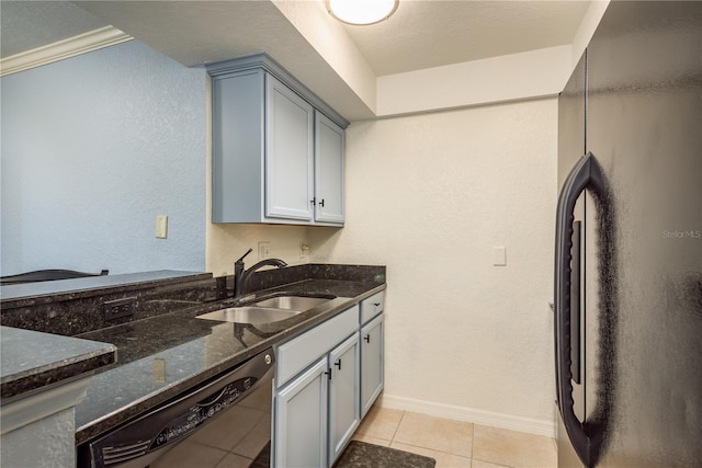 720 Lyndhurst St Unit 1121, Dunedin, FL 34698 - kitchen with freestanding refrigerator, a sink, dishwasher, dark stone counters, and light tile patterned flooring