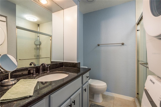 720 Lyndhurst St Unit 1121, Dunedin, FL 34698 - bathroom featuring toilet, a shower stall, vanity, tile patterned floors, and baseboards