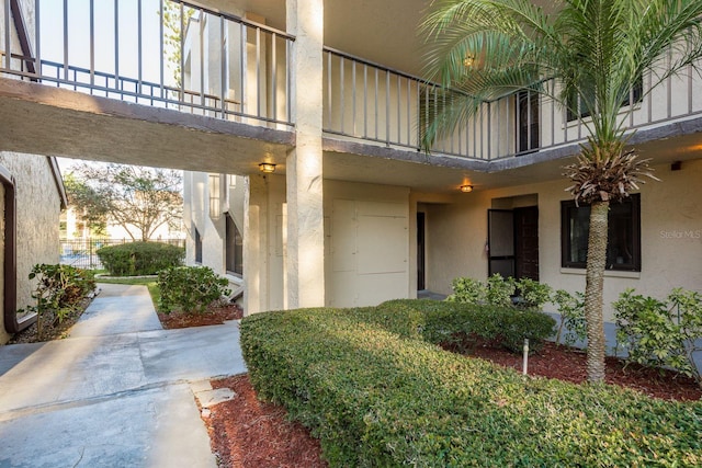 exterior space with a balcony and stucco siding