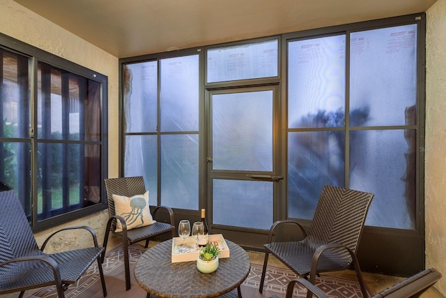 sunroom featuring a textured wall