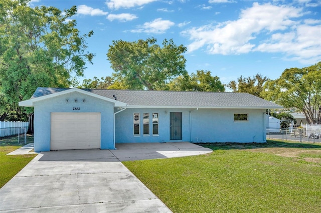 7323 Andre Dr, Zephyrhills, FL 33541 - single story home featuring a front lawn, stucco siding, fence, and a garage