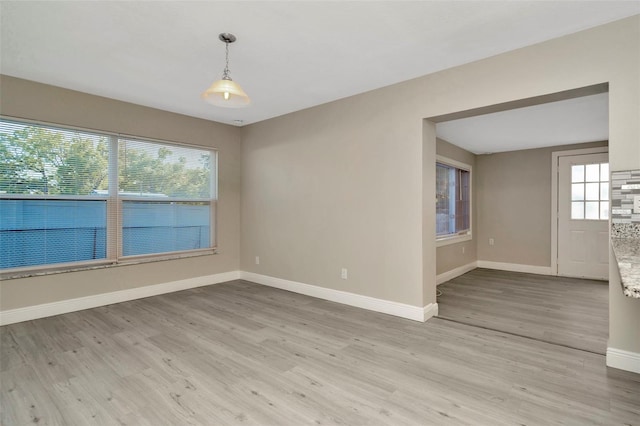 7323 Andre Dr, Zephyrhills, FL 33541 - unfurnished room with baseboards and light wood-style floors