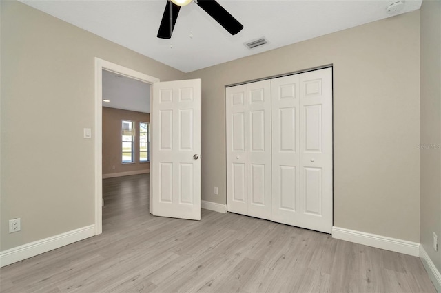 7323 Andre Dr, Zephyrhills, FL 33541 - unfurnished bedroom featuring a closet, baseboards, light wood-style floors, and visible vents